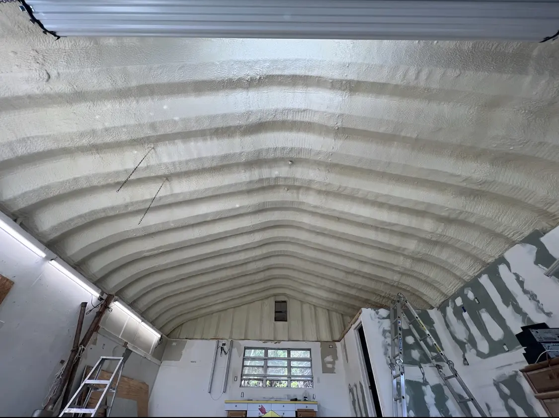 Spray polyurethane foam applied to the underside of a metal roof deck in Warren